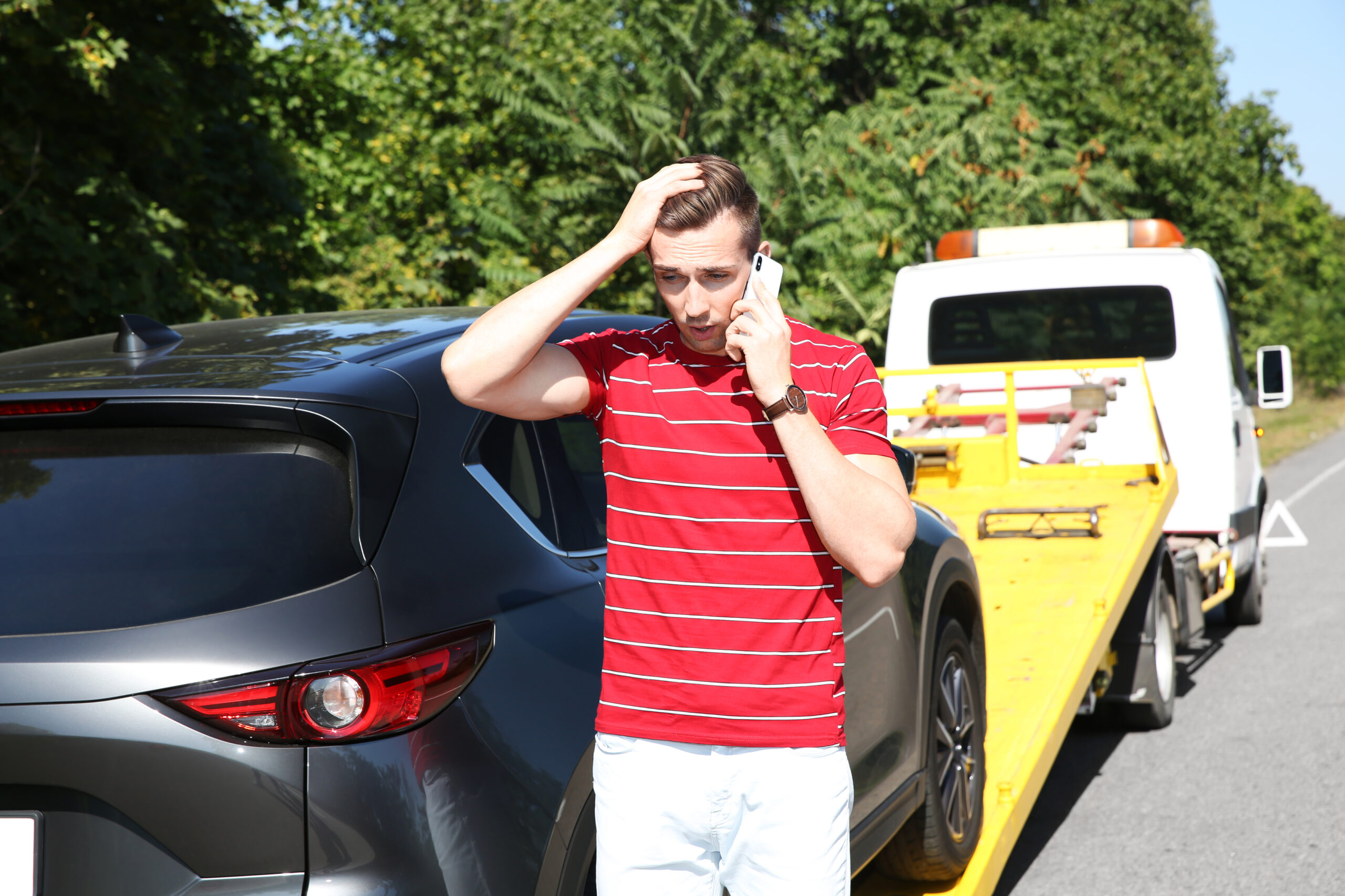 stranded car gets loaded on a flatbed